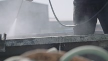 Construction workers cleaning steel concrete molds