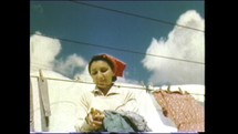 Menashe Heights, Israel, Circa 1940's. Color footage of everyday life in the Kibbutz. Woman hanging laundry to dry