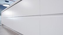 Tracking shot of a large luxury kitchen with white modern design