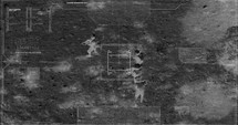 Military drone night vision thermal view of soldiers walking through a forest
