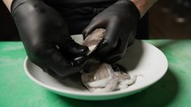 Chef Is Cleaning A Squid To Extract Black Ink Juice