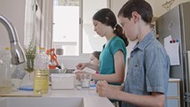 Kids preparing and mixing ingredients for pancakes in the kitchen