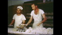 Menashe Heights, Israel, Circa 1940's. Color footage of baker baking bread in an oven