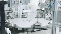 Advanced robotic machine manufacturing parts in an automated assembly line