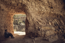 man siitting in a cave