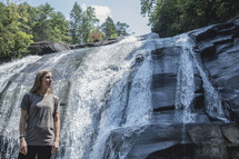 woman standing in front of a waterfall in Asheville, NC