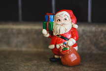 Santa figurine carrying presents