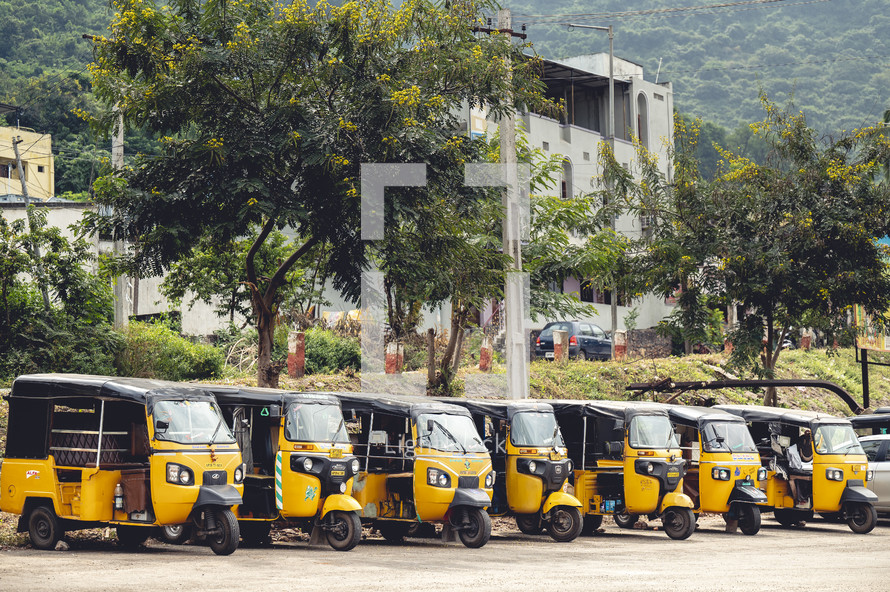 Yellow three-wheeled taxis in Vizag Visakhapatnam, India.