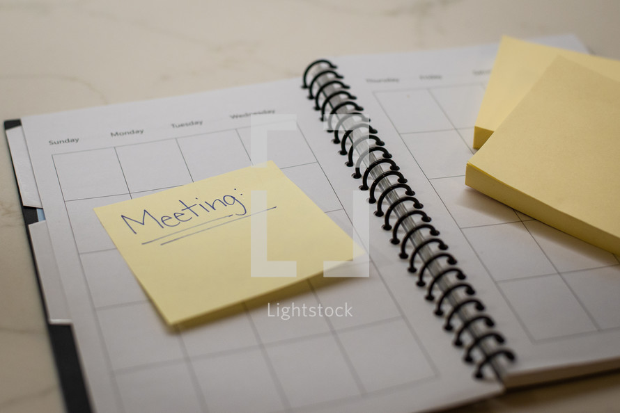 Notebook planner with sticky notes for meeting