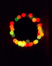 wreath Christmas light display at night 