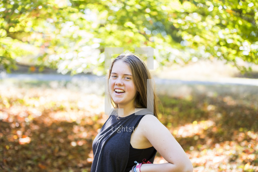 a happy teen girl outdoors in fall 