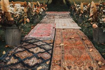 aisle of rugs for an outdoor wedding 