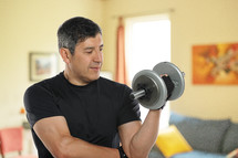 Mature man working out at home in his living room