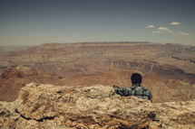 man standing looking out over the Grand Canyon