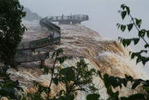 A walkway bridge on the edge of a Brazilian waterfall 