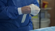 Slow motion of surgeon wearing surgical gloves before surgery