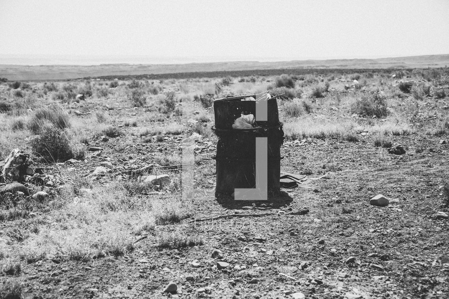 trashcan in the middle of a desert