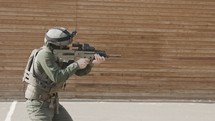 Slow motion of soldier shooting automatic rifle in a range
