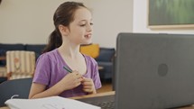 Little girl attending an online lesson during the COVID-19 lockdown