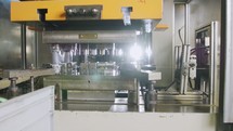 A large industrial punch press forming high precision metal parts for the automotive industry