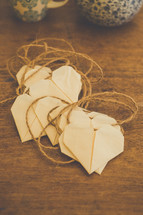 Paper hearts with twine hangers.