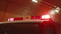 Emergency lights of a fire truck inside a tunnel