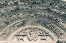 carvings on the wall of an ancient cathedral in France