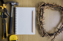 tools, notebook, and crown of thorns 