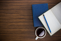 journal, Bible, and coffee cup on a desk 