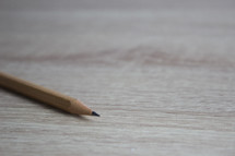 sharpened pencils on a wood background 