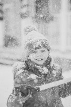 a kid playing in snow 
