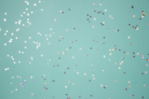Turquoise background with silver and gold star glitter