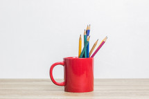 pencils in a red mug 