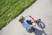 boy child riding his bike 