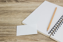 blank notecard and blank pages of a notebook 