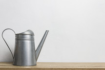 watering can against a white background 