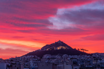 vibrant red sky over a town in Greece 