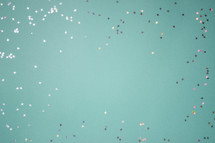 Turquoise background with silver and gold star confetti