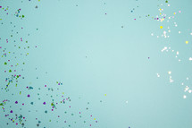 Turquoise background with colorful heart confetti