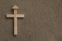 cross made of wooden blocks on carpet 