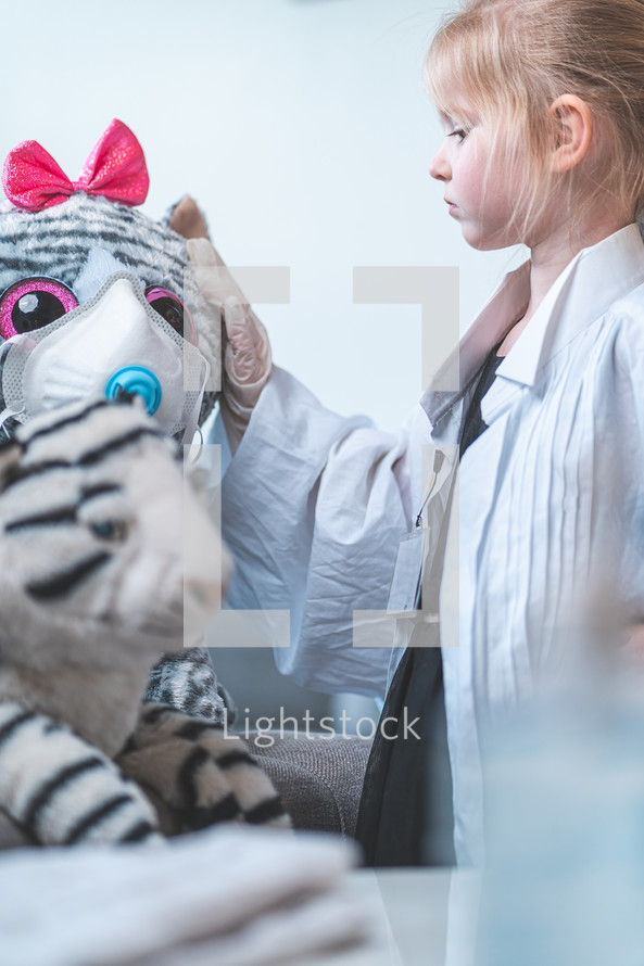 little girl pretending to be a doctor 