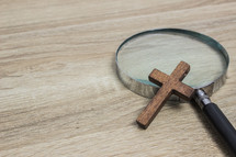 cross and magnifying glass 