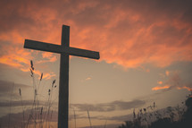 cross outdoors at sunset 