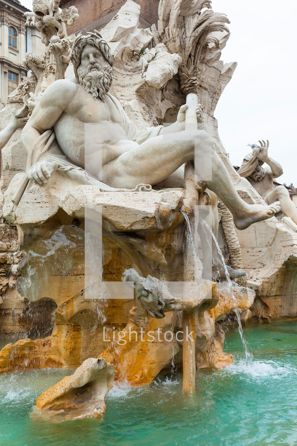tatue of the god Zeus in Bernini's Fountain of the Four Rivers in Piazza Navona, Rome. Detail of the allegorical Ganges figure.