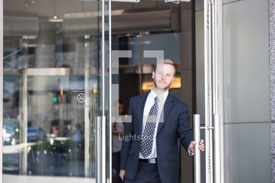 businessman opening a door 