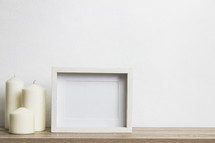 three candles and blank frame 