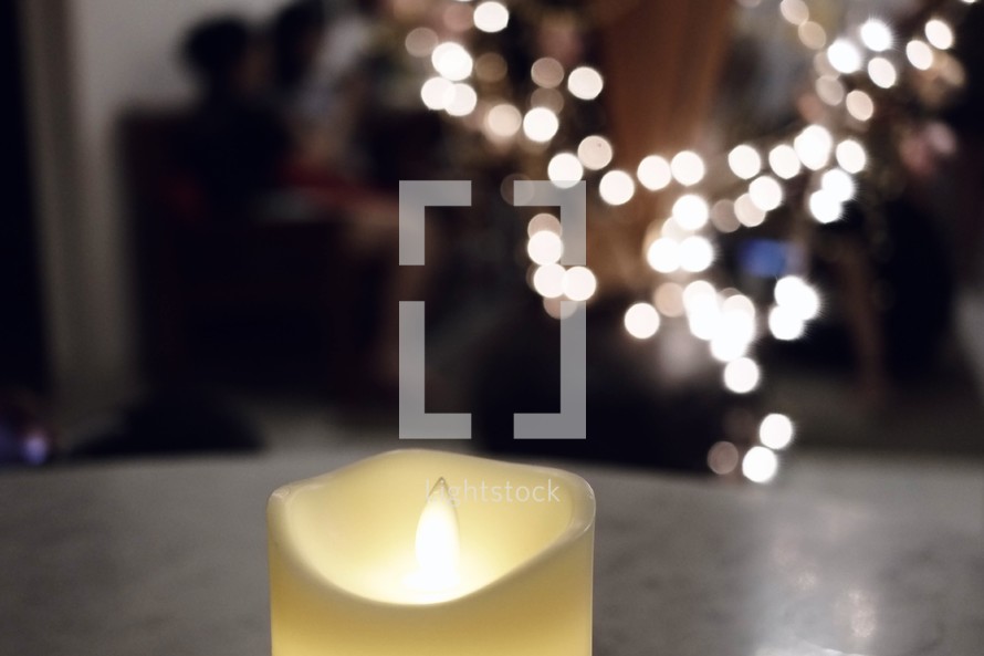 Candle in front of bokeh lights