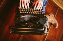 Woman typing on old typewriter