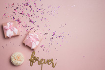 wrapped gifts on a pink background 