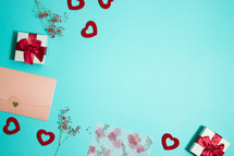 red hearts, and gift on turquoise background 